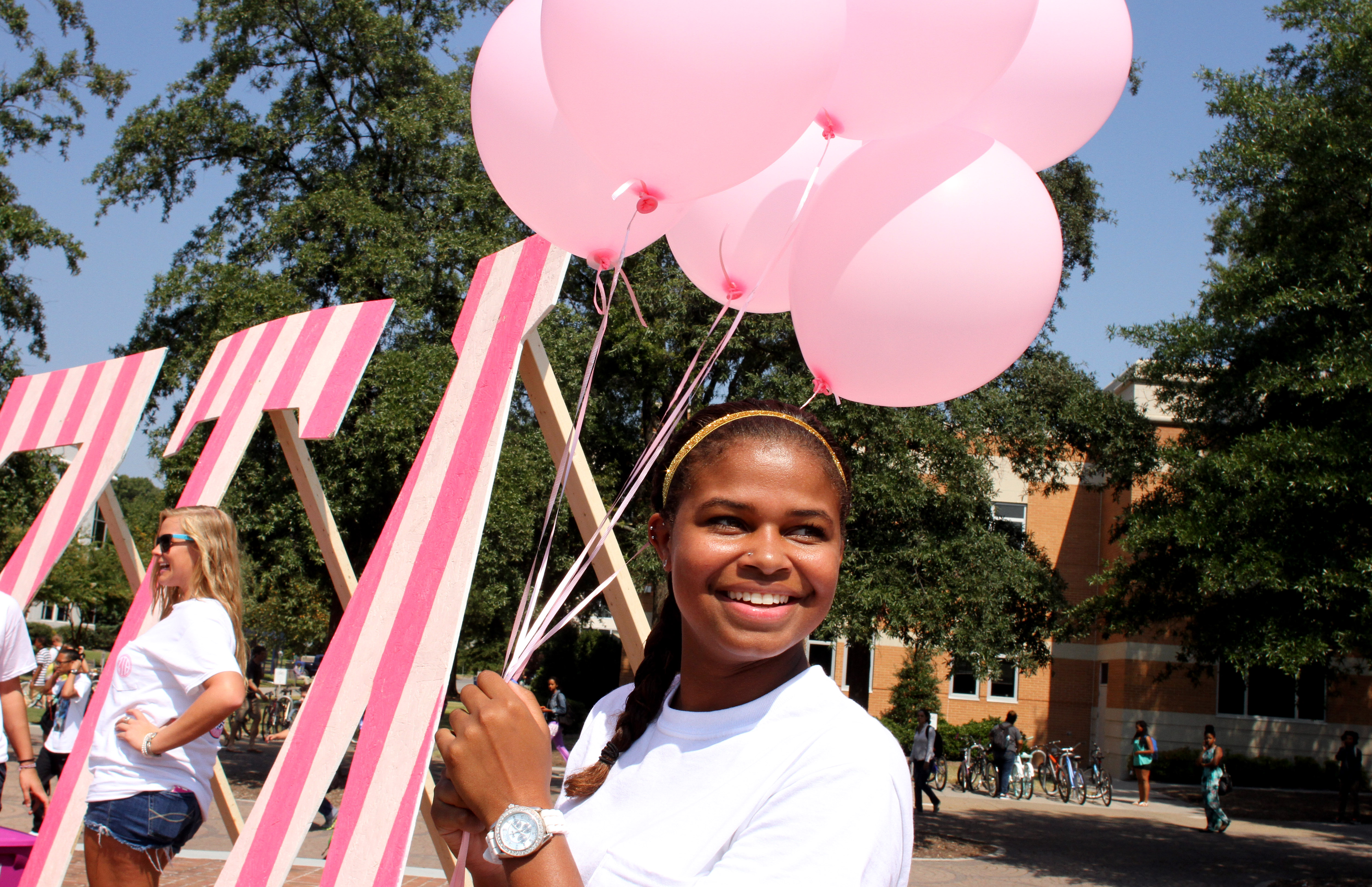 ZTA member Rachel Bryant, a sophomore psychology/human services major, helped decorate for the rally with pink balloons.