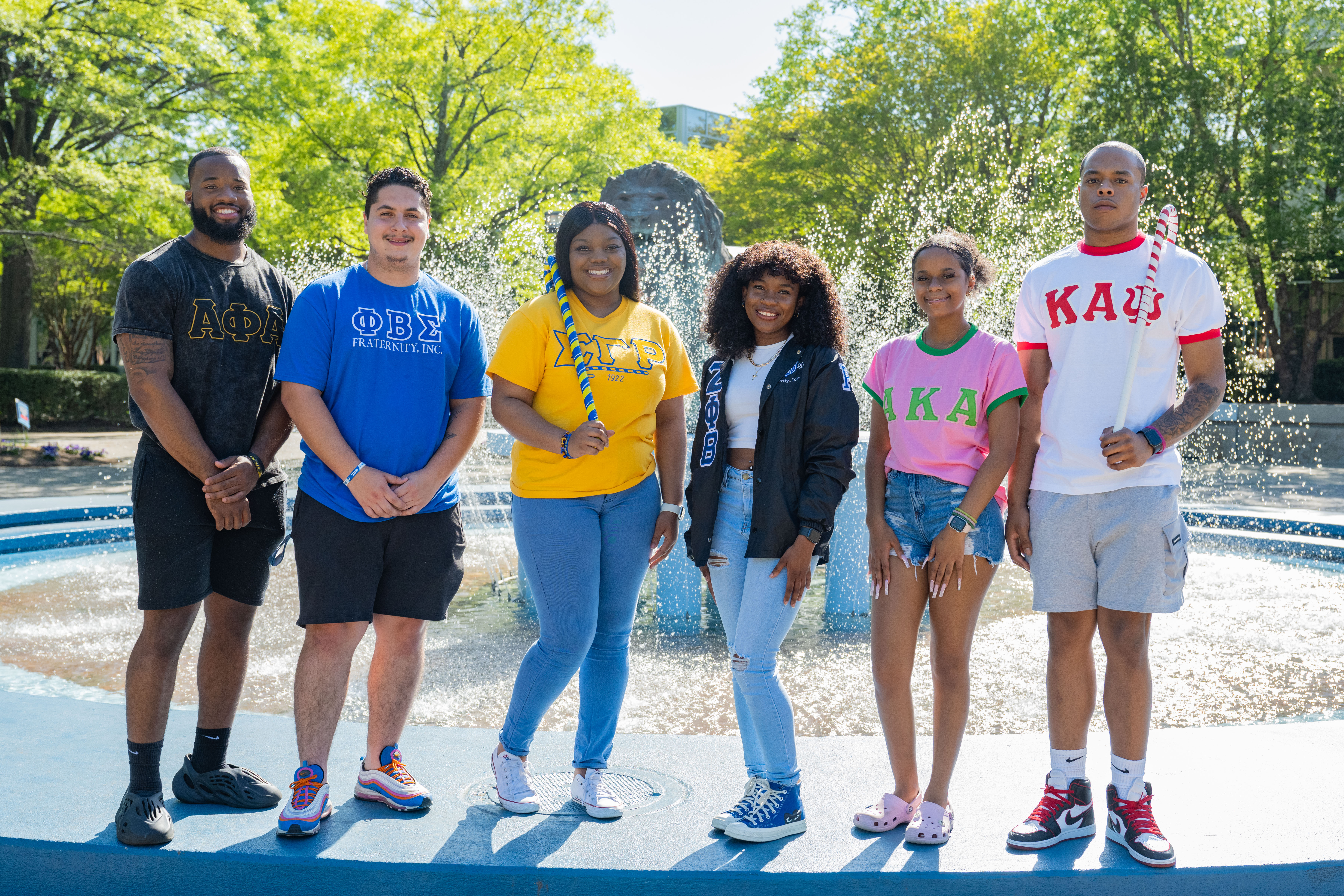 National Panhellenic fraternity and sorority members stand in front of fountain