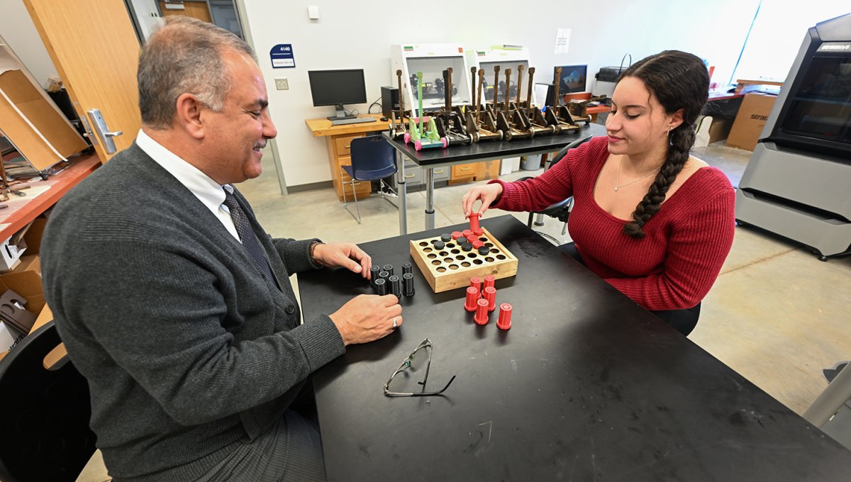 Dr. Matrood and his student demonstrate how to play with one type of toy they created.