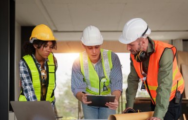 Architect team working with blueprints for architectural plan, engineer sketching a construction project