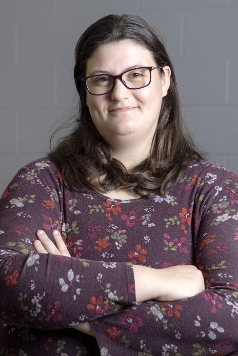 Paige Laning standing with arms crossed