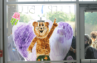 Big Blue spreads peace and love to students on a window at Webb Center.  Photo Chuck Thomas/ODU