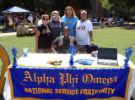 Members of Alpha Phi Omega pose for a photo at their table. Photo David B. Hollingsworth/ODU