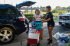 Allana Johnston, right, loads her sister Alexis' stuff onto a dolly outside Rogers Hall. Photo Chuck Thomas/ ODU