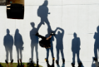Students cast shadows as they wait for the pumpkin drop to begin. Photo Chuck Thomas/ODU