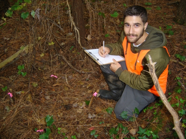 ODU student Eric Cali checks forest floor plot for insects and spiders that birds could eat.   