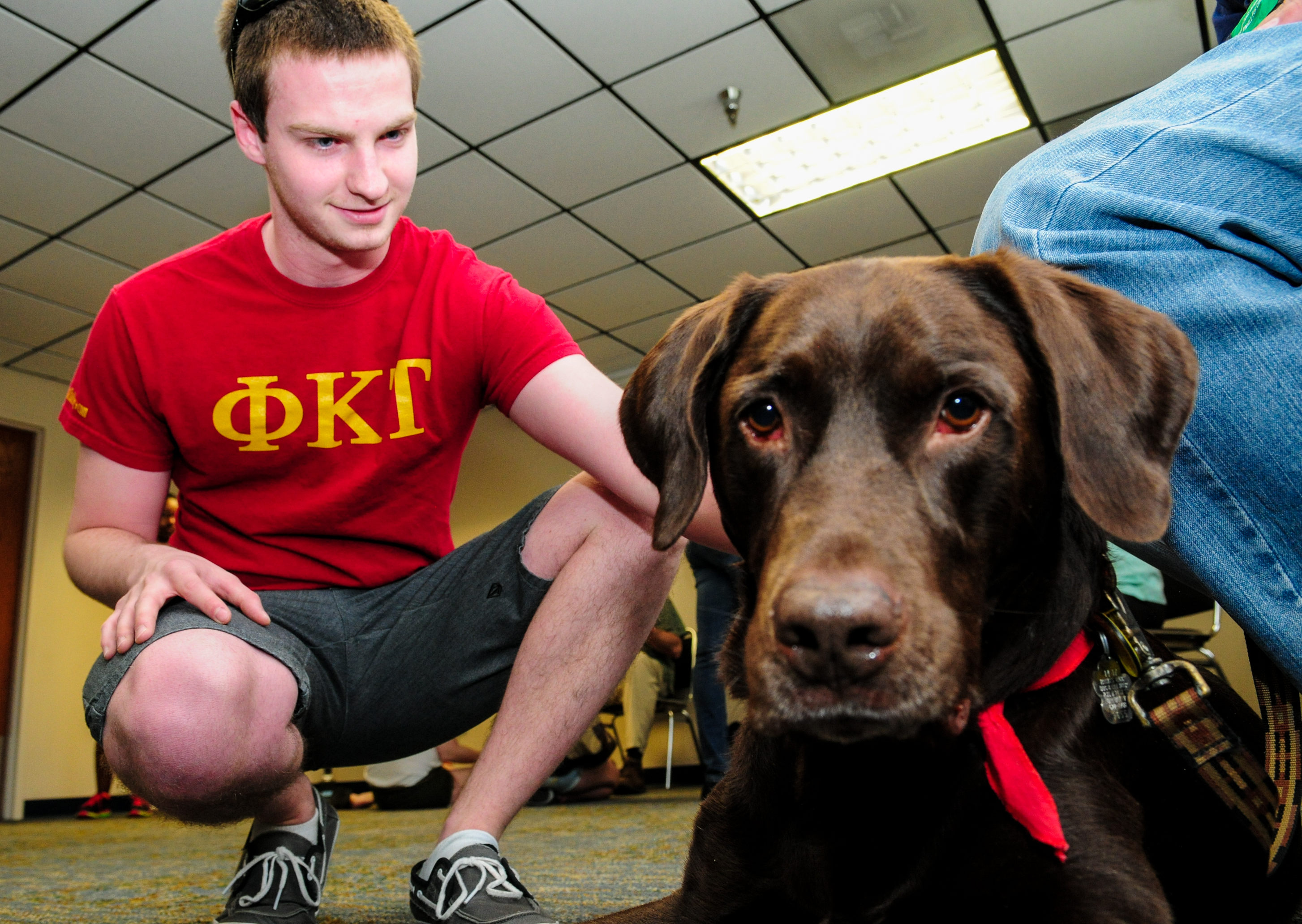 this is a photo of freshman Alex Johnson with de-stressing dog.
