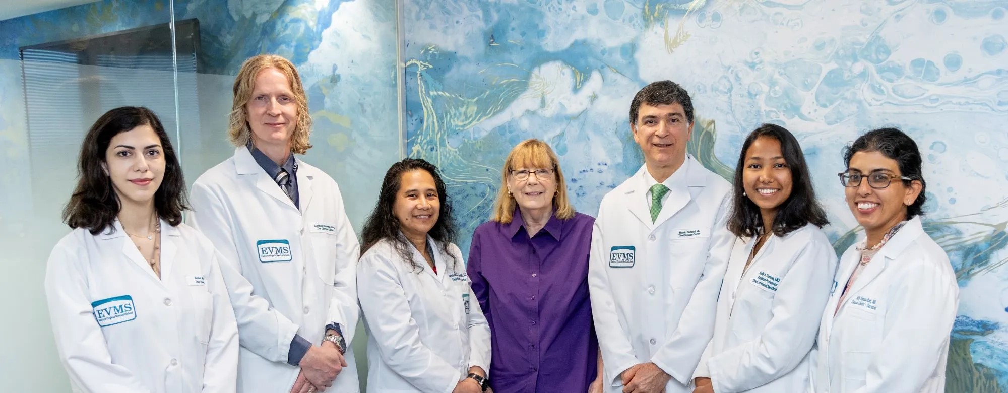 Six doctors and one administrator smile at the camera