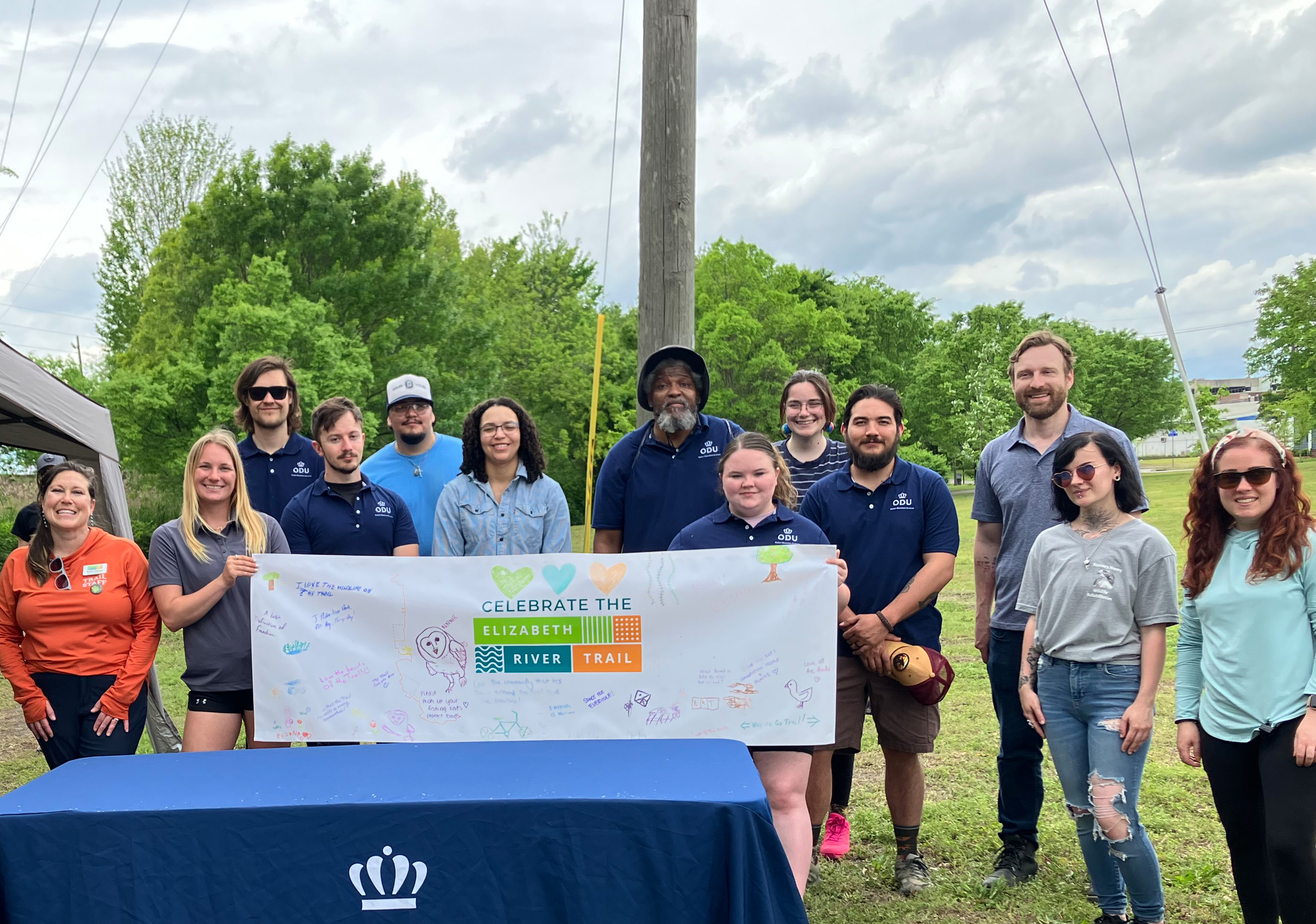 Students & Faculty with an Elizabeth River Project Sign