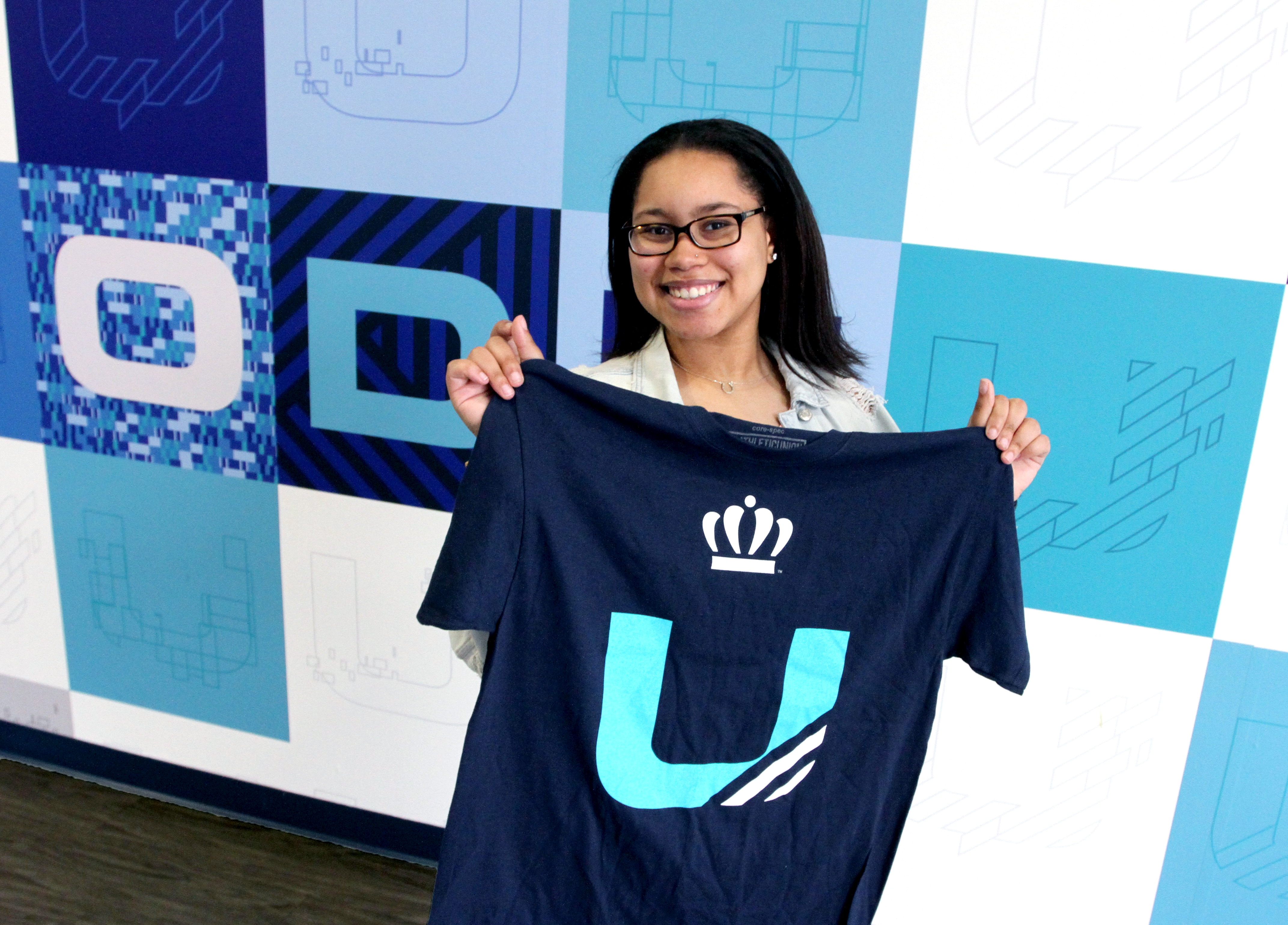 Female student holding ODU t-shirt