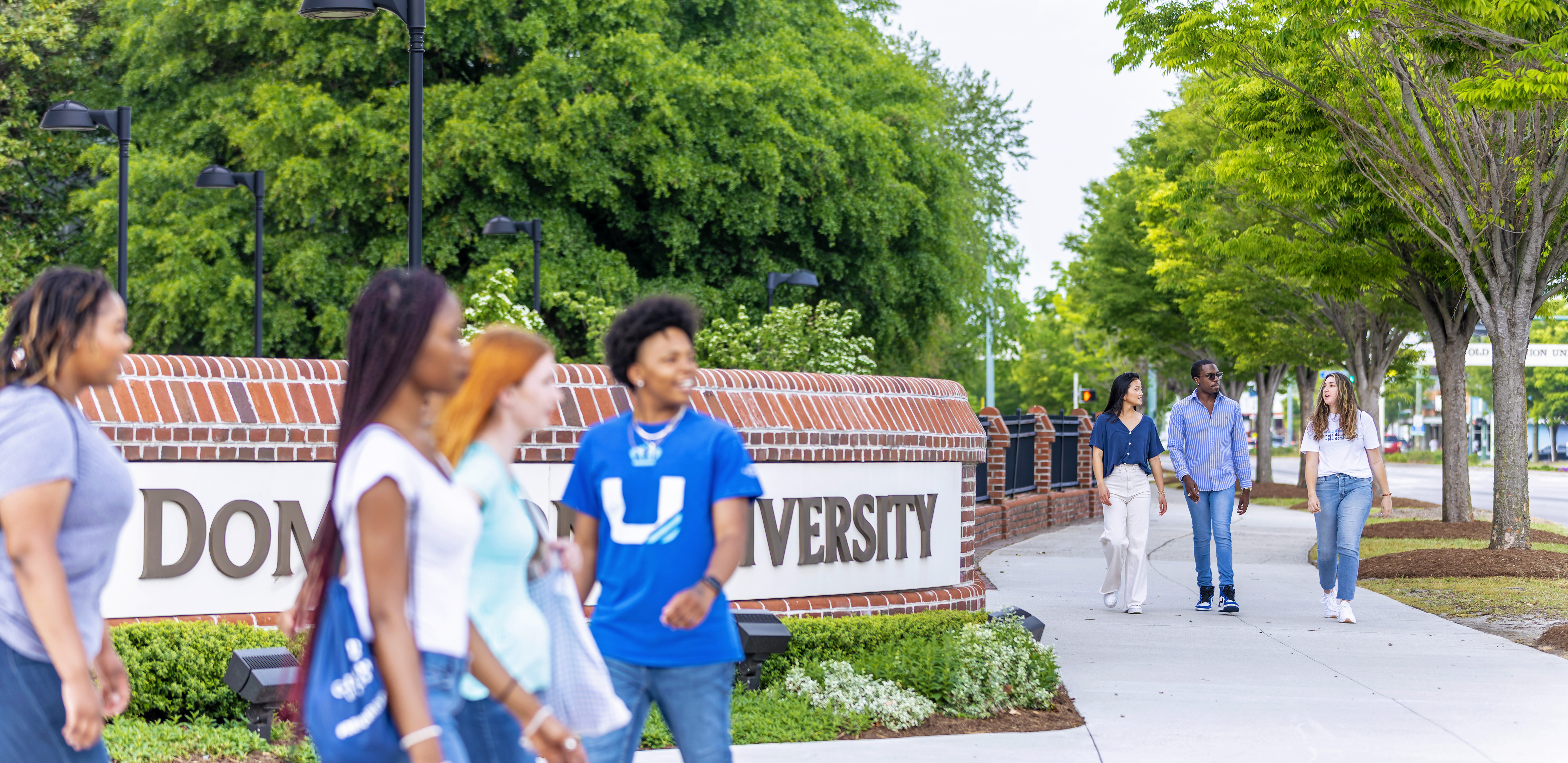 Groups of students walking in front of the education building