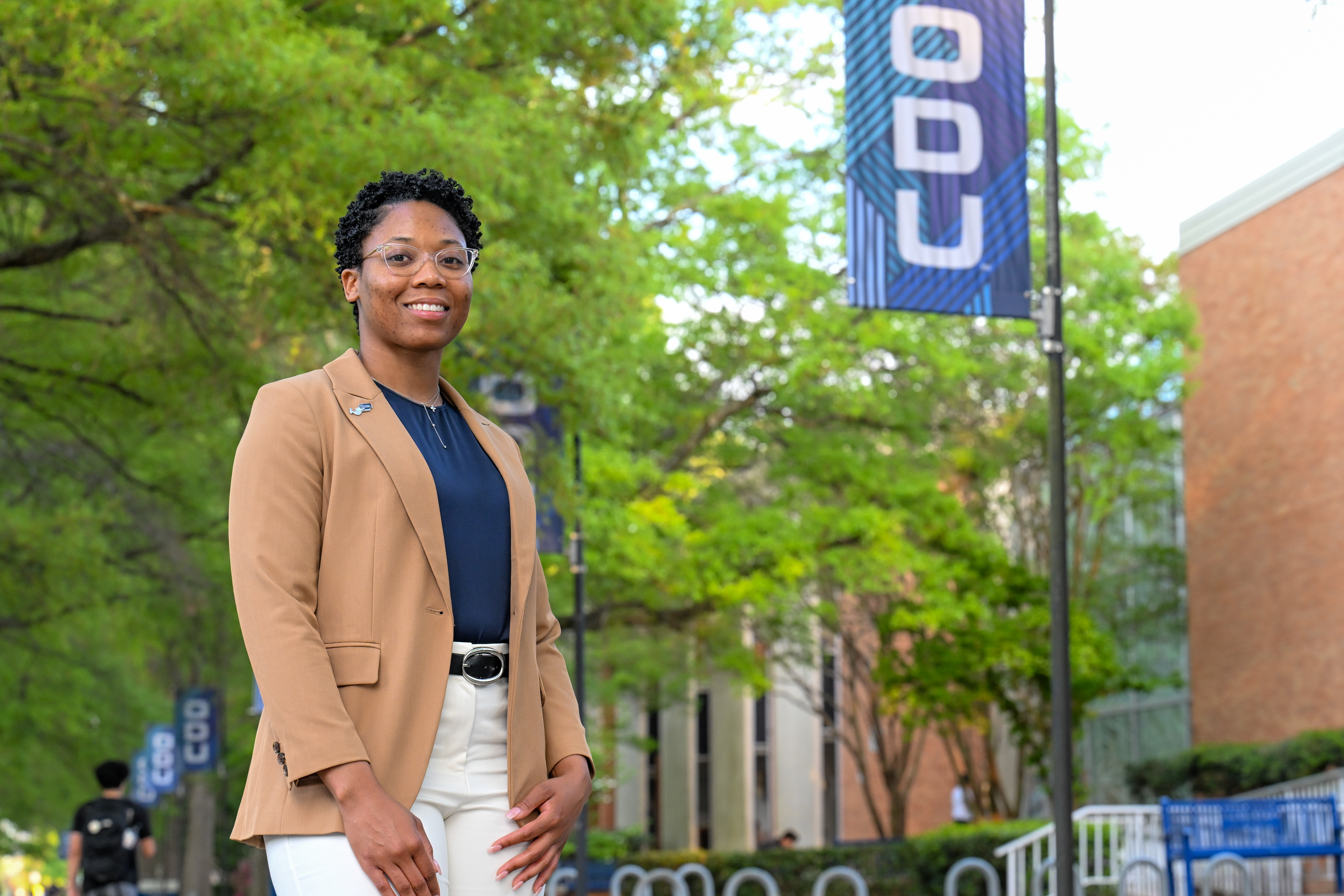 woman stands in front of building