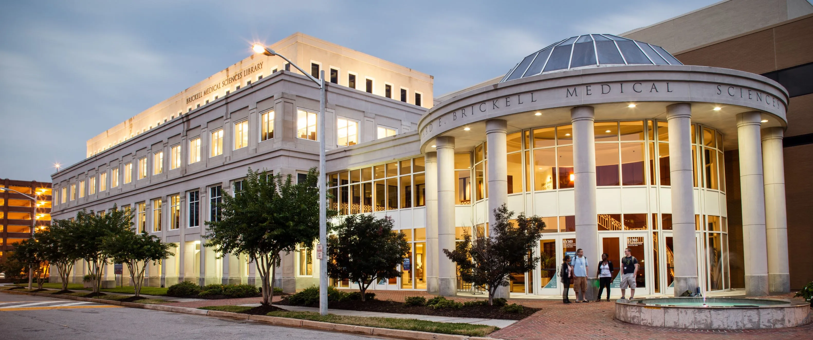 Four students standing at library entrance