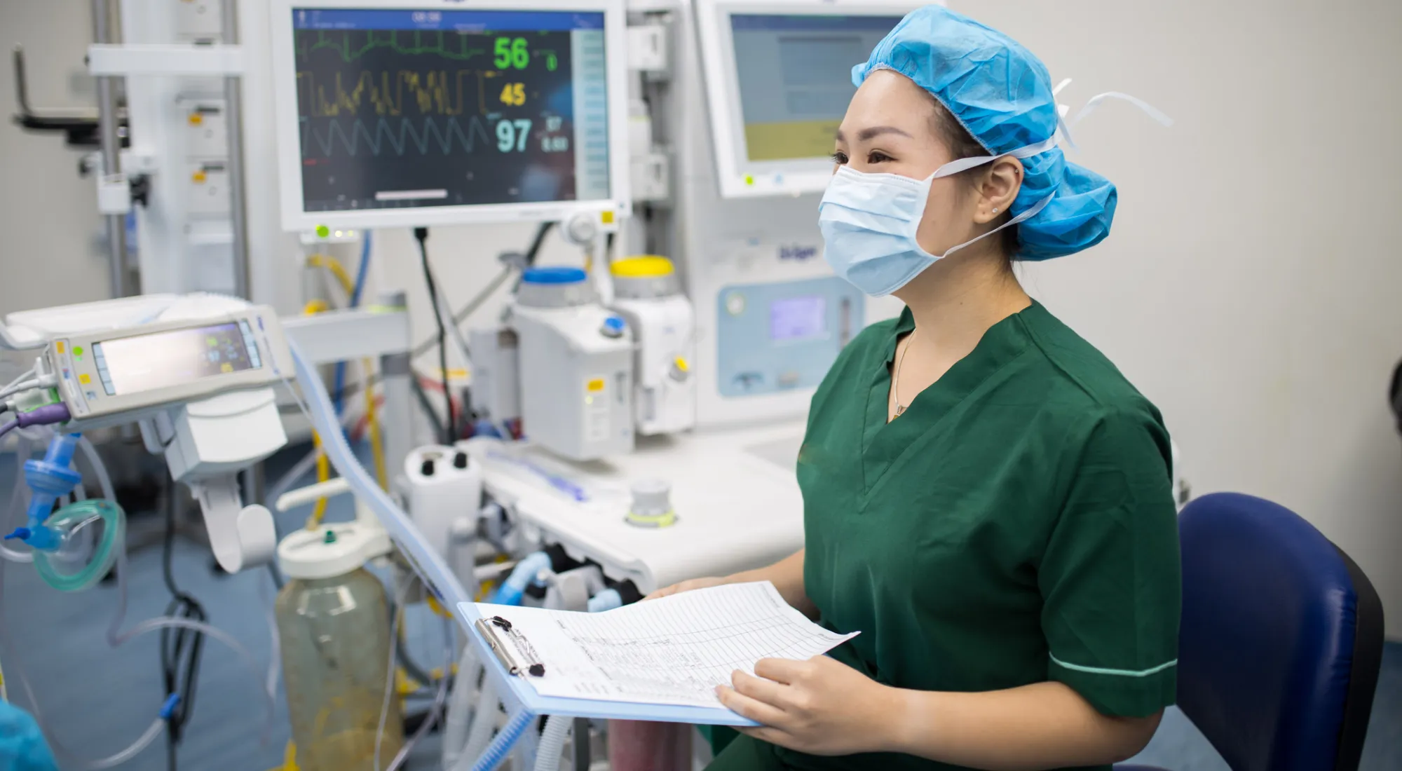 Doctor in green scrubs wearing a mask