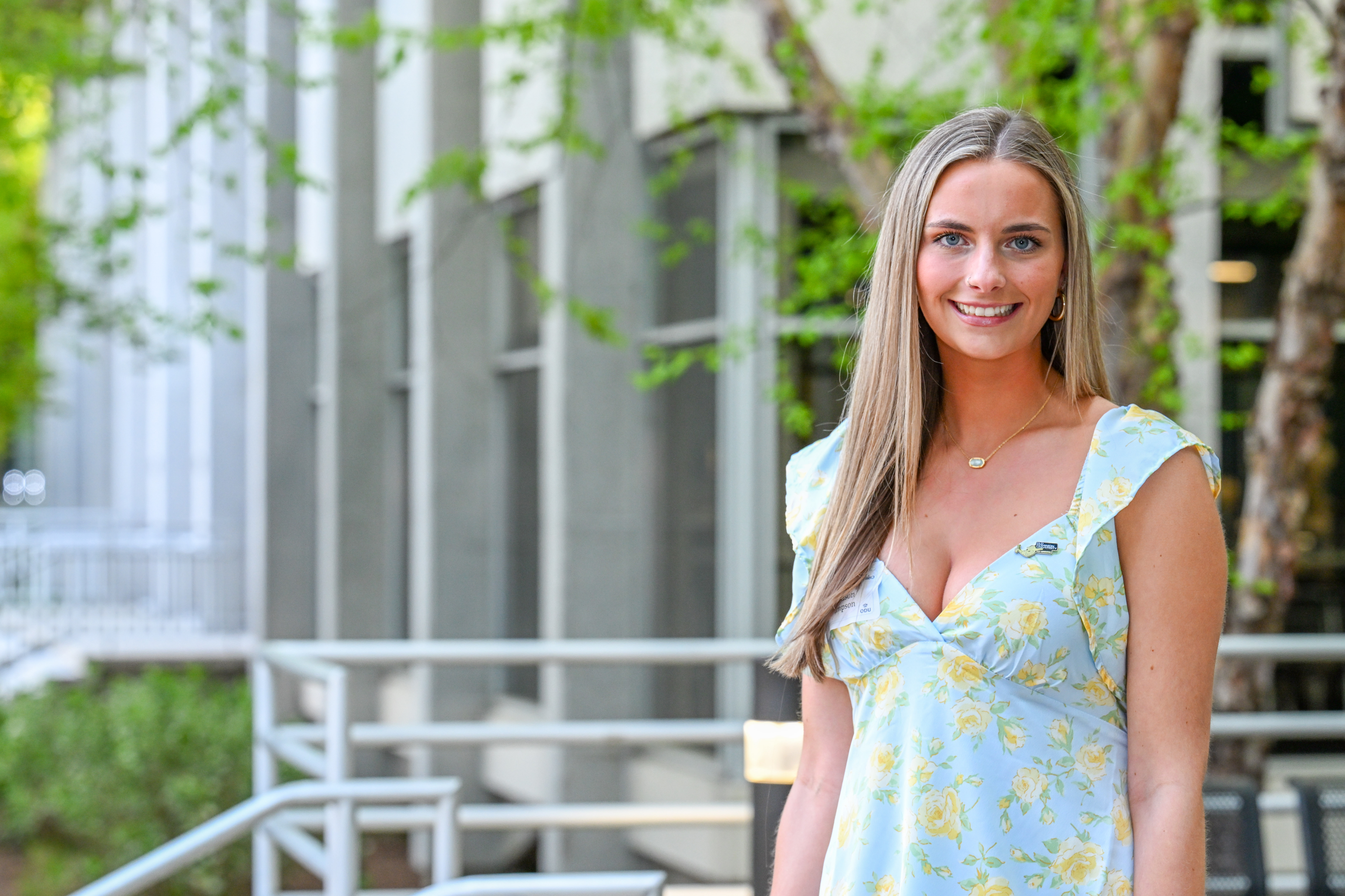Woman stands in front of building