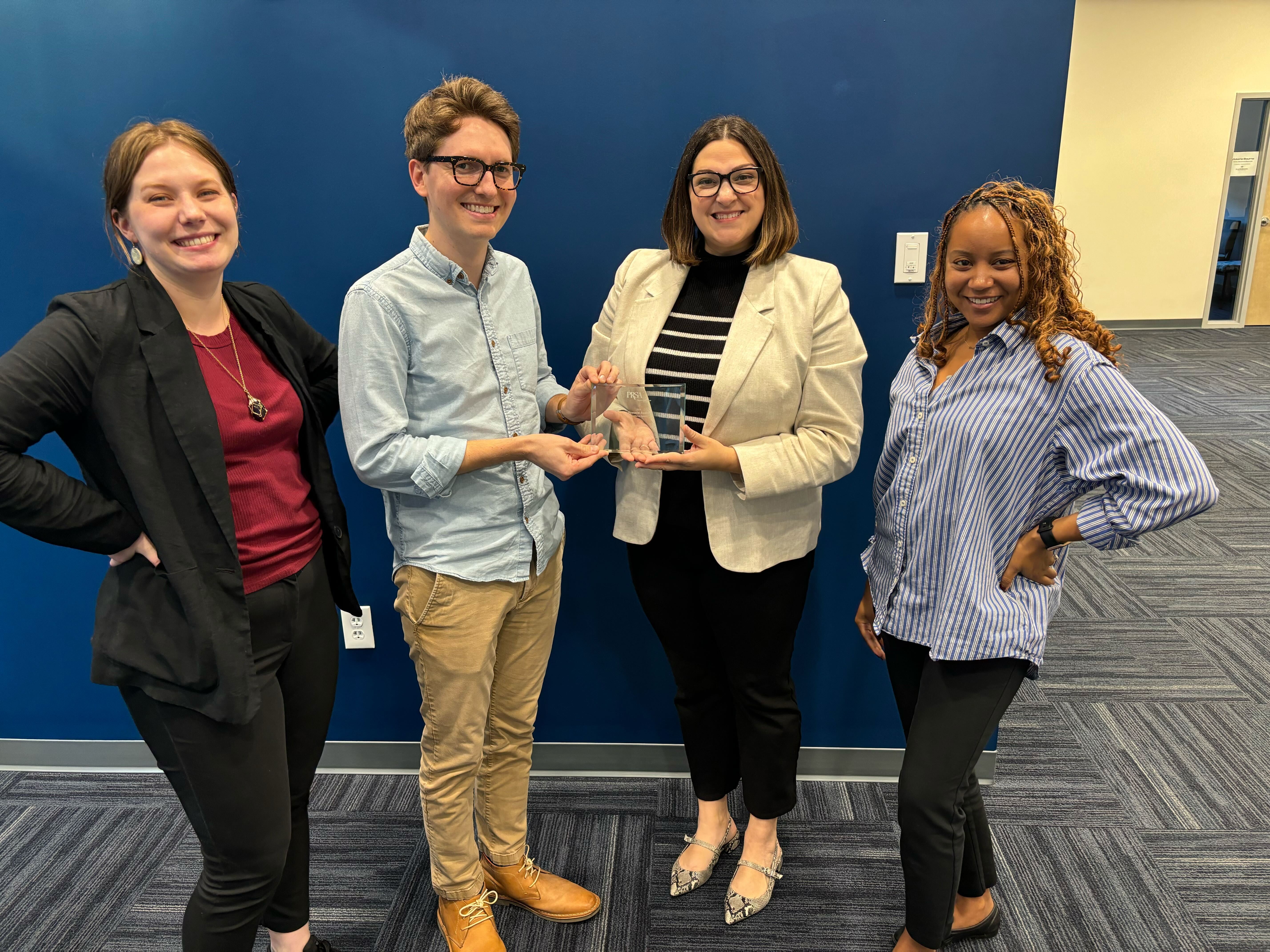 A group of people holding an award.