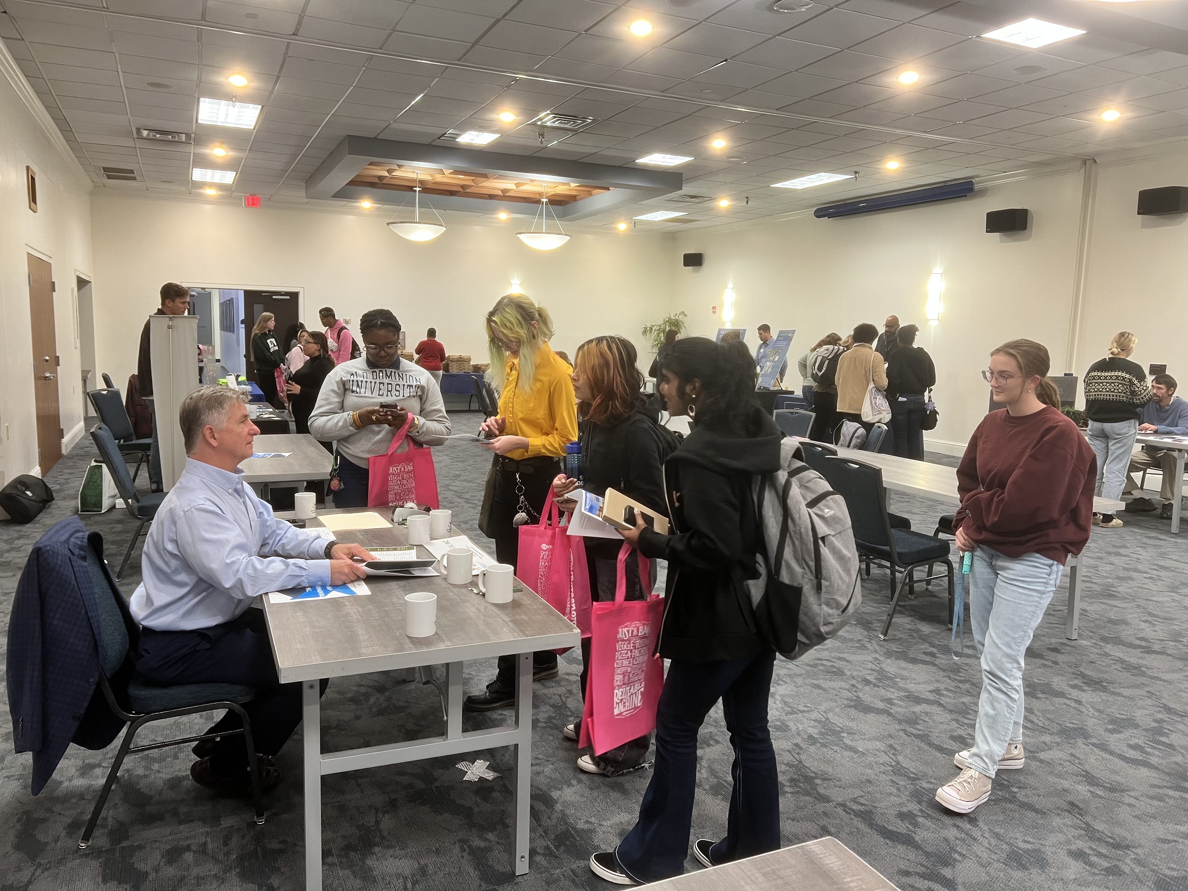 Students meeting with representative at a career fair.