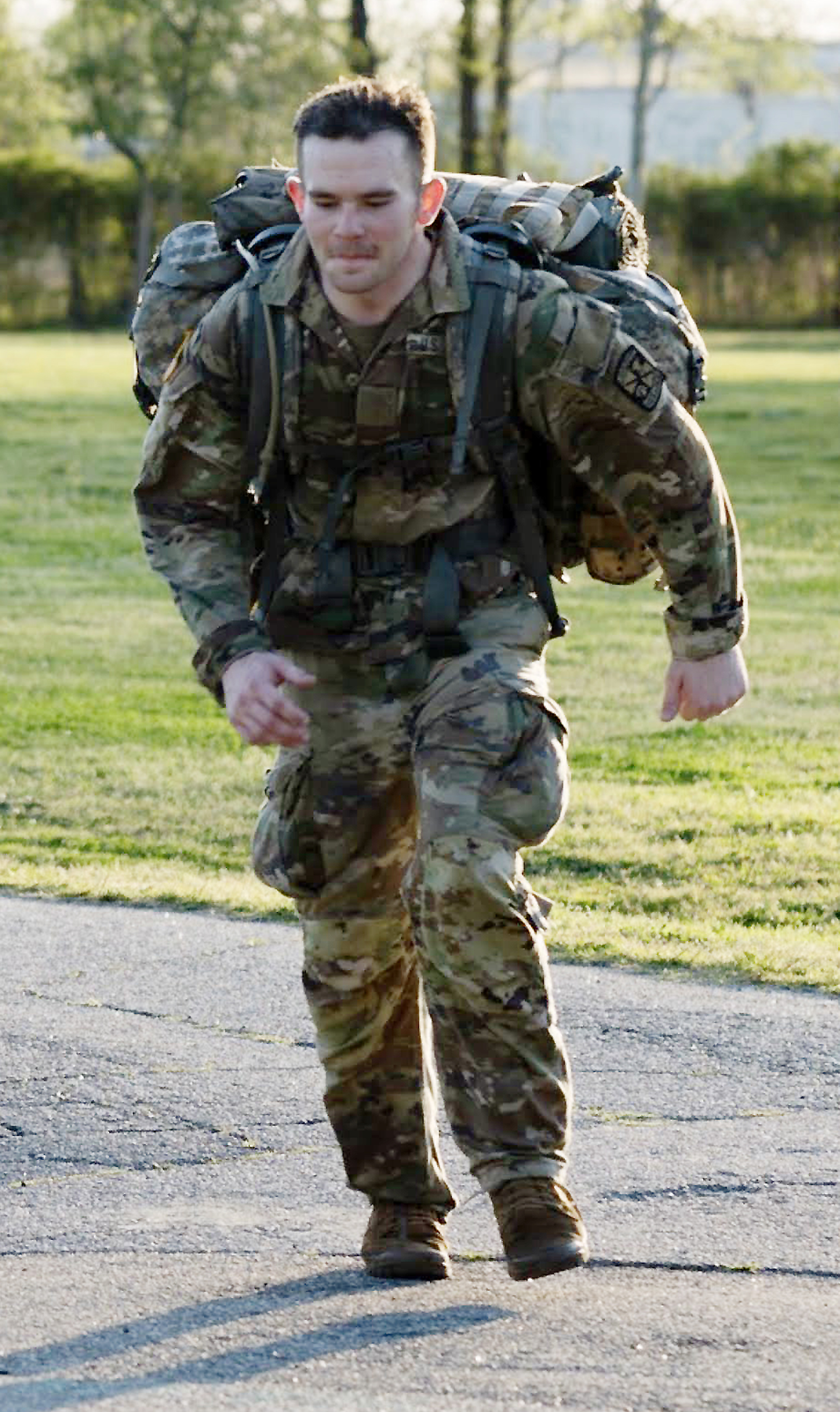 Man carries heavy backpack during military bootcamp