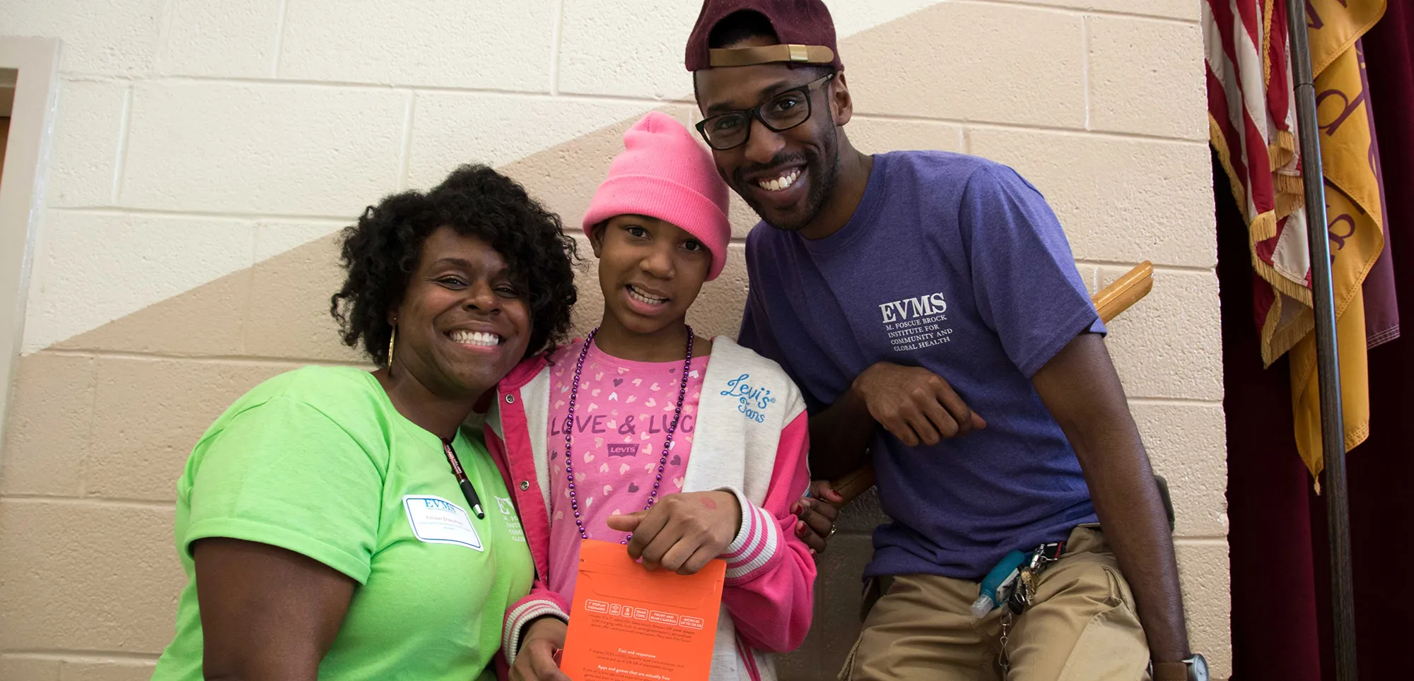 Students and volunteers with a child at a community event