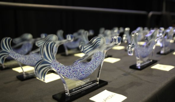 Glass mermaid-shaped awards on a table