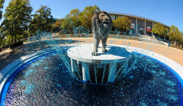 Lion statue in the middle of a waterfall 
