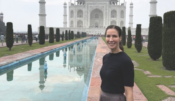 Helen Crompton, Ph.D., stands outside the Taj Mahal in India 