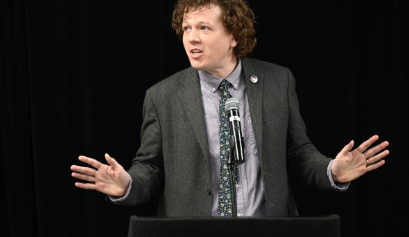 a man stands at a lectern