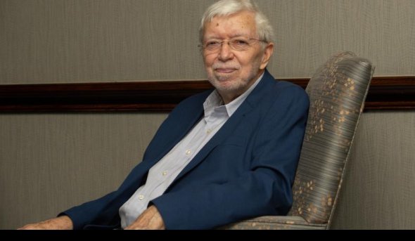 Wayne Talley, Ph.D., seated in a chair