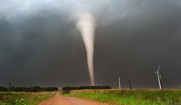 Image of a tornado crossing a plain.