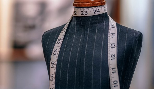 Fashion mannequin with measuring tape around neck 