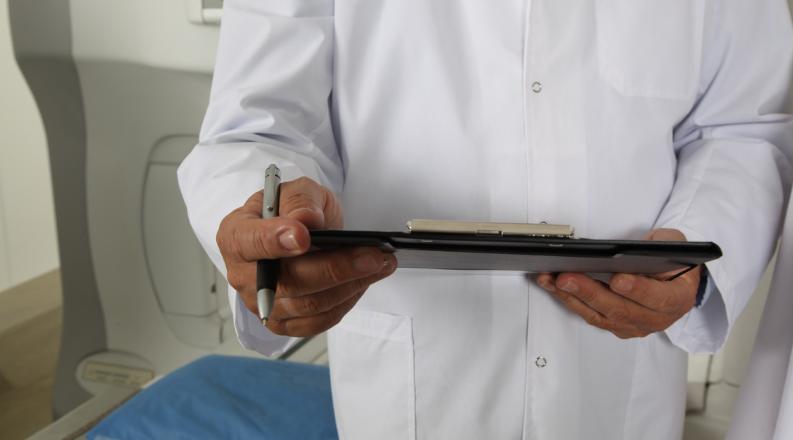 a physician assistant looking at a notepad