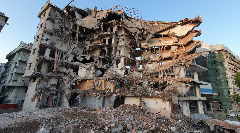 A collapsed building in Turkey surrounded by rubble after an earthquake struck the country on February 6, 2023. 