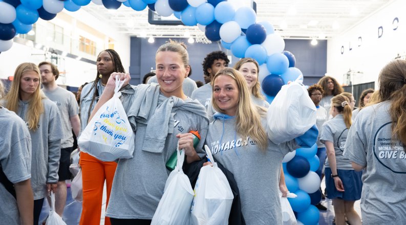 students holding donation bags