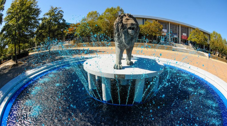 Lion statue in the middle of a waterfall 