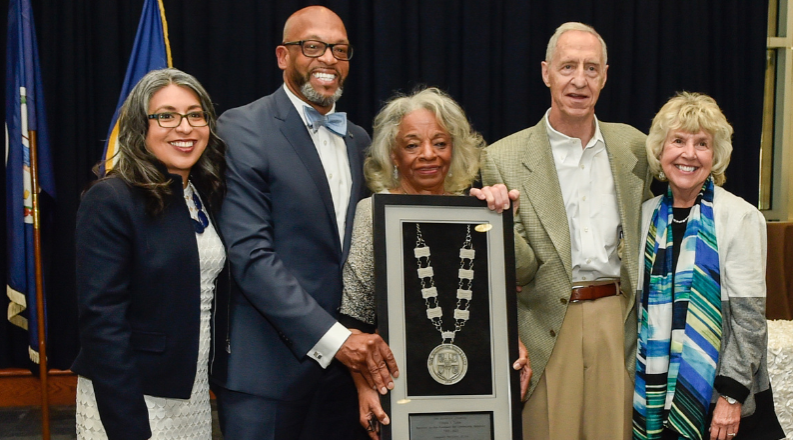 A photo of Cee Cee Tucker being presented with the presidential medallion for distinguished service.