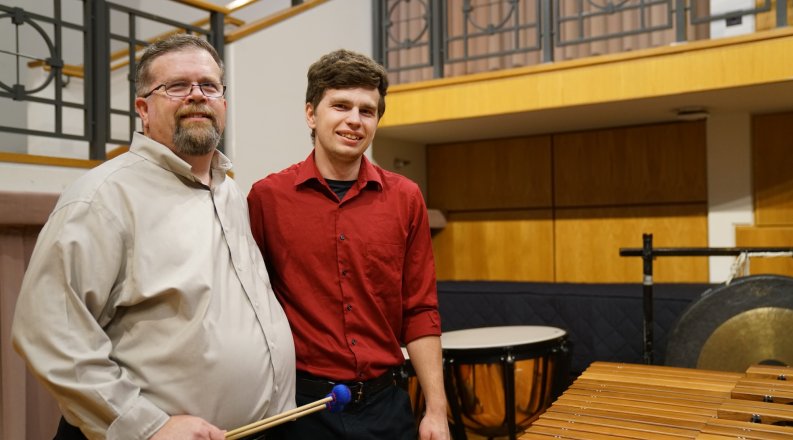 David Walker, left, is director of percussion studies at Old Dominion University. Here, he poses on stage at Chandler Recital Hall with his son Michael, a percussionist and student at ODU.