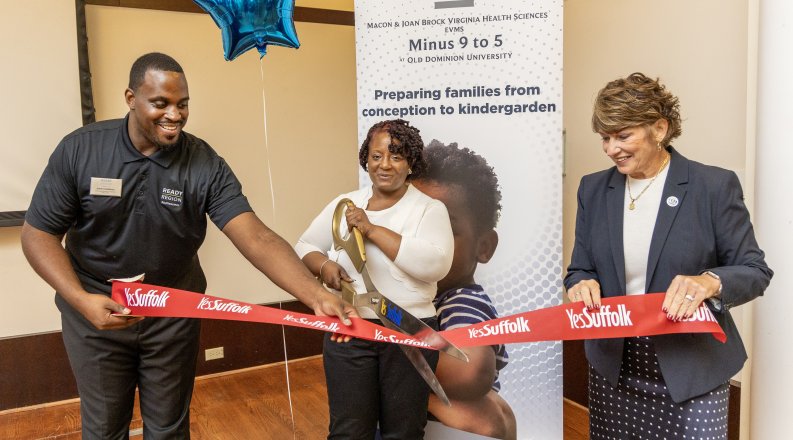 People cutting a ribbon at a ribbon-cutting event