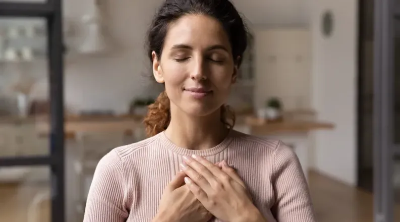 Woman with a hand over her heart
