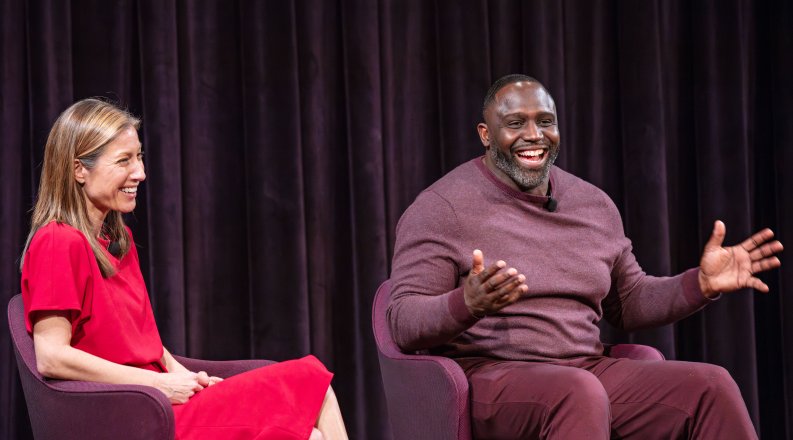 Two people sitting and talking