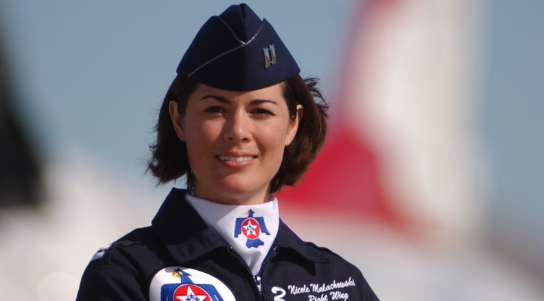 woman stands before jet