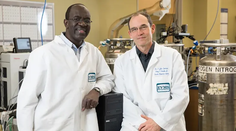 Two researchers sitting next to each other in the lab.