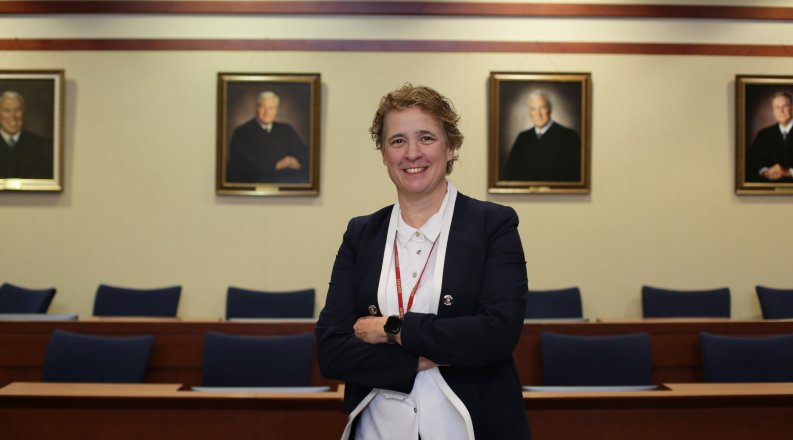 a woman stands in a court chamber