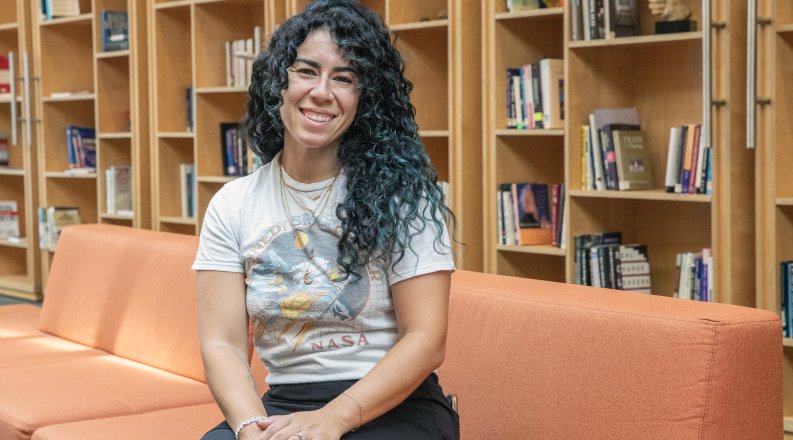 a woman sits on a couch