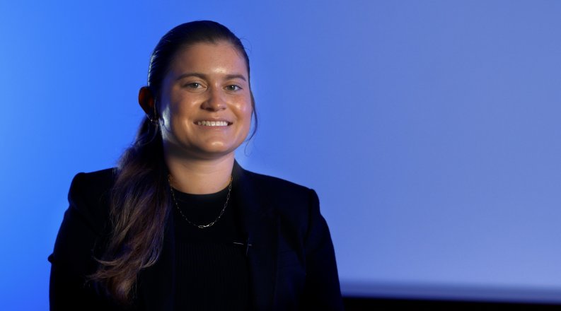 Portrait of young woman on blue background