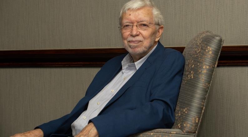 Wayne Talley, Ph.D., seated in a chair