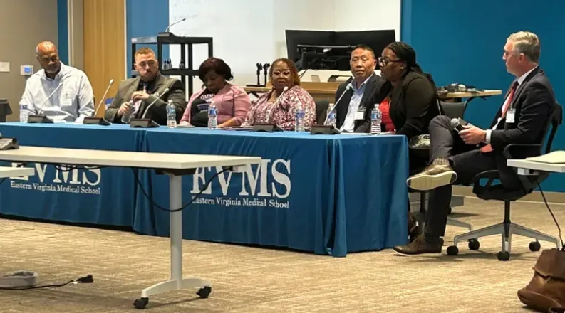 CEREQ representatives sit at a table during a conference