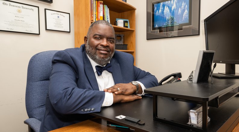 A man sits at a desk