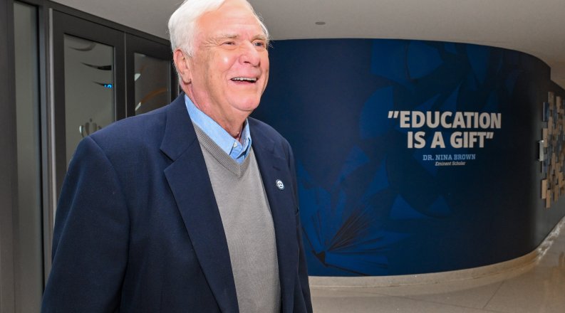 ODU alumnus Don Musacchio stands in the hallway in the Education Building 
