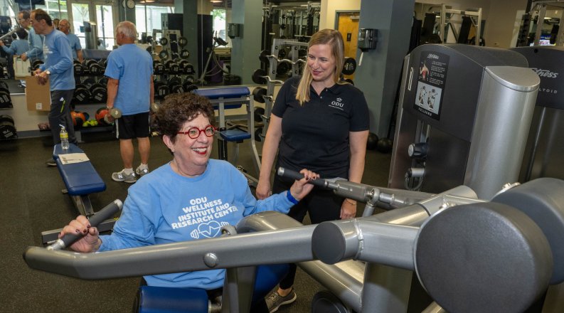 Elderly woman exercising on fitness machine