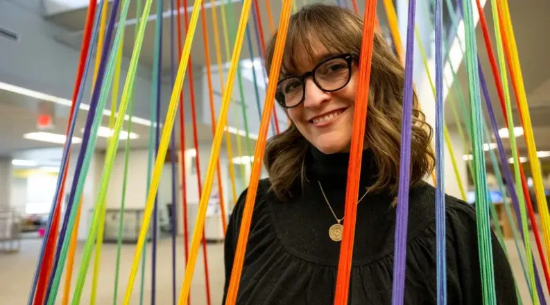 EVMS student Kim McCoy stands with her new art installation 